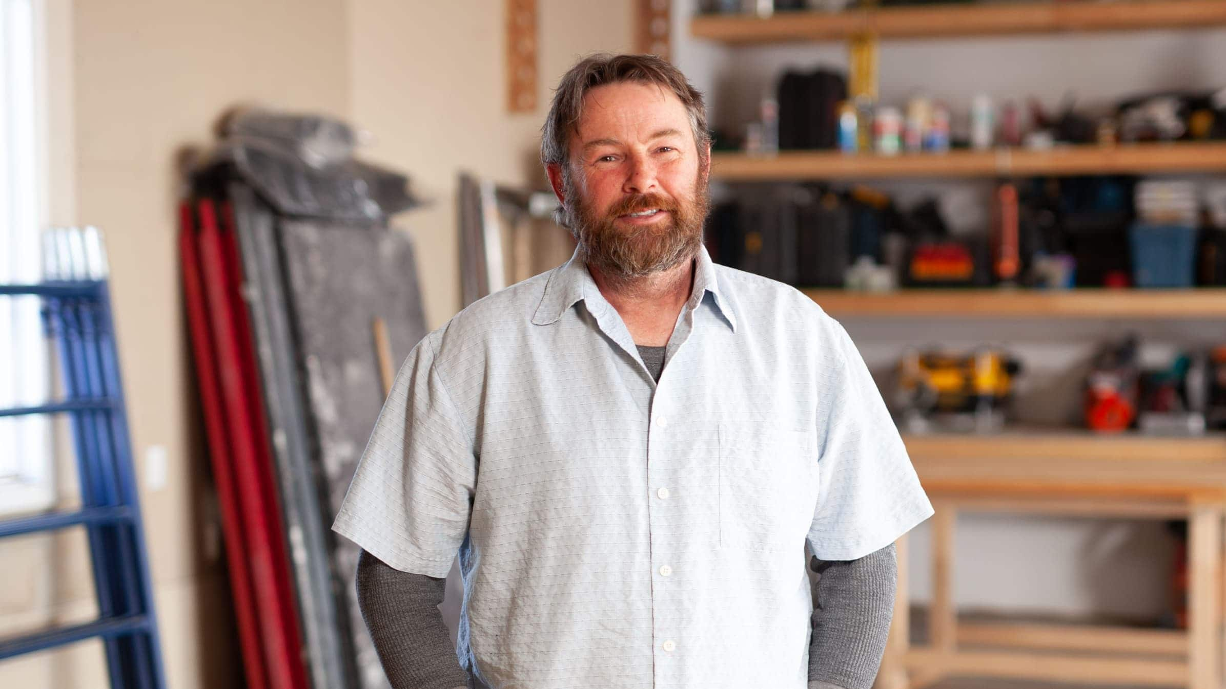 Brad Dodds, owner of Dodds Building and Contracting, standing in a workshop smiling to camera.